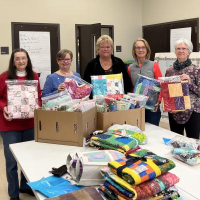 Beautiful quilts for survivors and overcomers handmade by these wonderful volunteers-what a blessing!