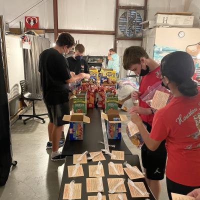 Students at The HUB-Houston prepare snack bags with trafficking information